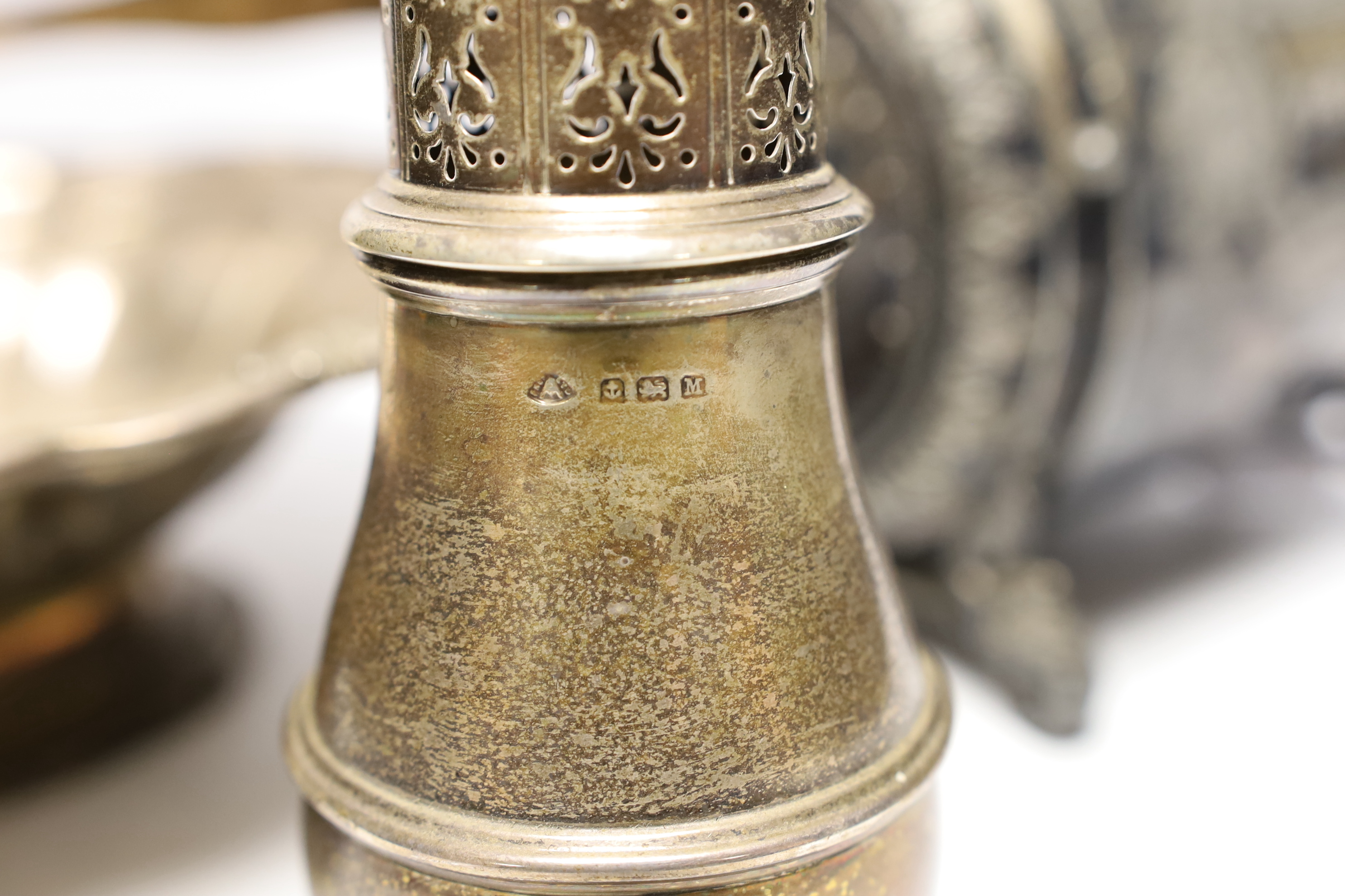 A George IV silver bread basket, London, 1827? (marks rubbed), diameter 31cm, together with a 1930's silver sugar caster, gross 40.2oz and a Brittania metal biscuit barrel.